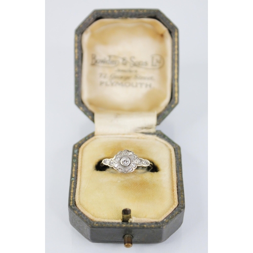 146 - An Edwardian diamond cluster ring, the central old cut diamond approximately 2.30mm diameter, with f... 