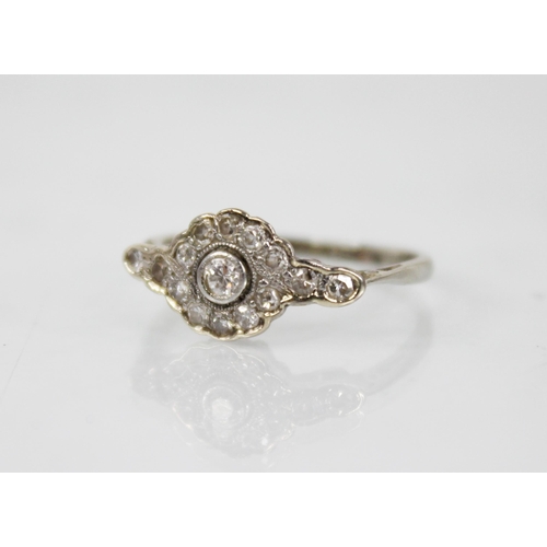 146 - An Edwardian diamond cluster ring, the central old cut diamond approximately 2.30mm diameter, with f... 