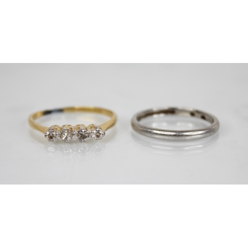 147 - An early 20th century four-stone ring, comprising two central round old cut diamonds, flanked by a c... 