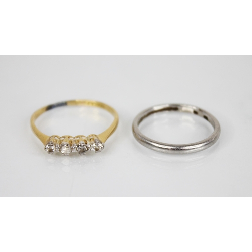 147 - An early 20th century four-stone ring, comprising two central round old cut diamonds, flanked by a c... 