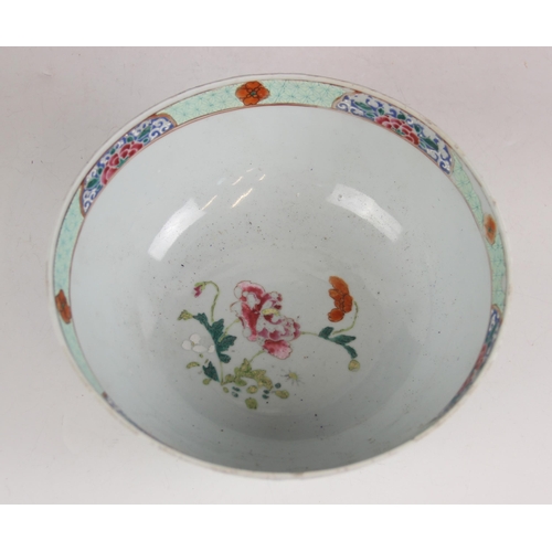 297 - A Chinese porcelain famille rose bowl, Qianlong (1735-1796), of circular form and decorated with flo... 