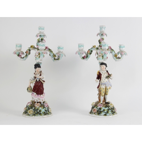 385 - A pair of continental porcelain five branch figural candelabra, late 19th century, one modelled with... 