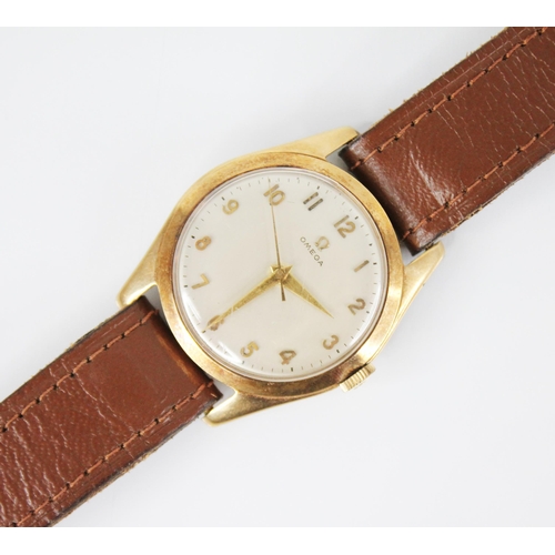 55 - A gentleman's 9ct gold vintage Omega wristwatch,  the circular cream dial with Arabic numerals, set ... 