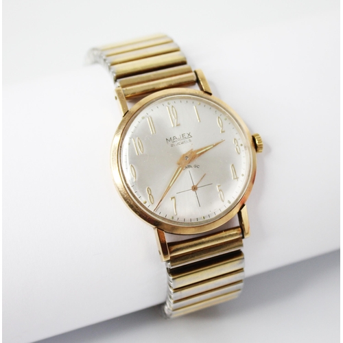 57 - A gentleman's vintage 9ct gold Majex wristwatch, the circular silvered dial with Arabic numerals wit... 