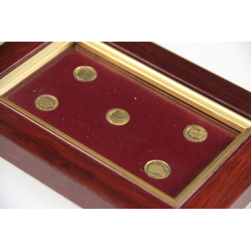 45 - A framed set of five gold coloured coins, each approximately 10mm diameter, each depicting a histori... 