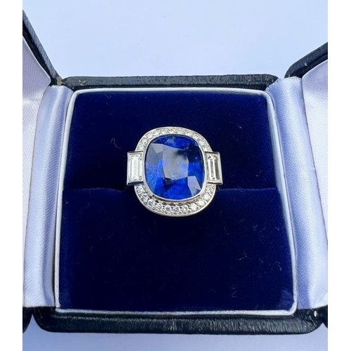 133 - An Art Deco Revival sapphire and diamond ring, the central cushion cut blue sapphire measuring appro... 