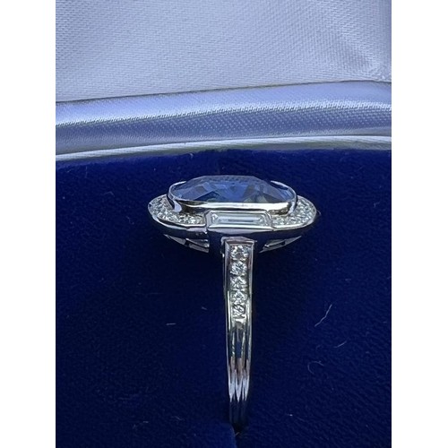 133 - An Art Deco Revival sapphire and diamond ring, the central cushion cut blue sapphire measuring appro... 