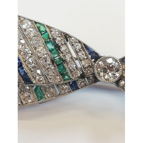 97 - An Art Deco diamond, sapphire and emerald bow brooch, the central round old cut diamond weighing app... 