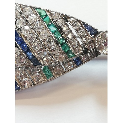 97 - An Art Deco diamond, sapphire and emerald bow brooch, the central round old cut diamond weighing app... 