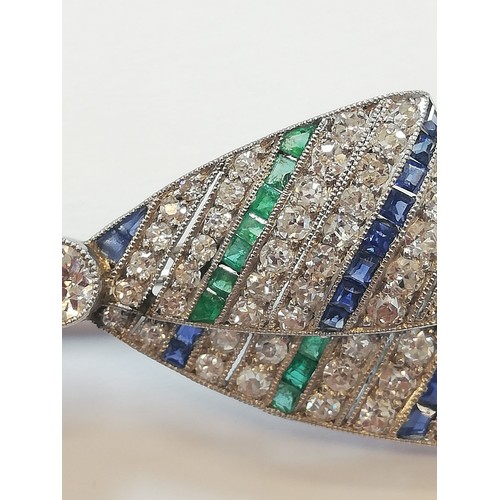 97 - An Art Deco diamond, sapphire and emerald bow brooch, the central round old cut diamond weighing app... 