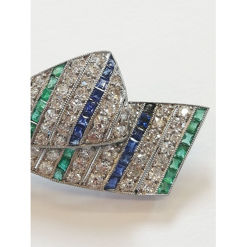 97 - An Art Deco diamond, sapphire and emerald bow brooch, the central round old cut diamond weighing app... 