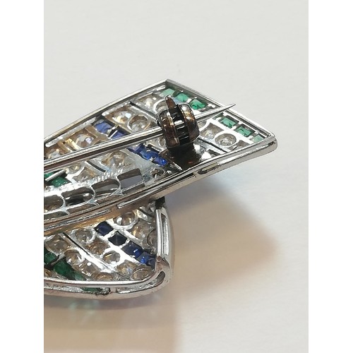 97 - An Art Deco diamond, sapphire and emerald bow brooch, the central round old cut diamond weighing app... 