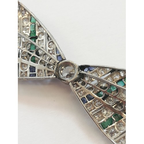 97 - An Art Deco diamond, sapphire and emerald bow brooch, the central round old cut diamond weighing app... 