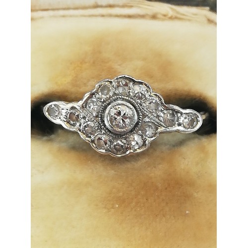 146 - An Edwardian diamond cluster ring, the central old cut diamond approximately 2.30mm diameter, with f... 