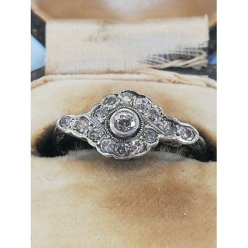 146 - An Edwardian diamond cluster ring, the central old cut diamond approximately 2.30mm diameter, with f... 