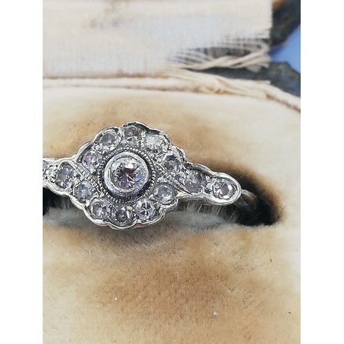 146 - An Edwardian diamond cluster ring, the central old cut diamond approximately 2.30mm diameter, with f... 