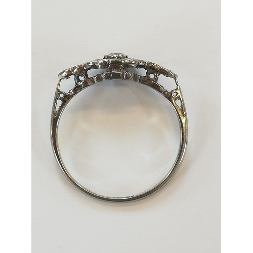 146 - An Edwardian diamond cluster ring, the central old cut diamond approximately 2.30mm diameter, with f... 