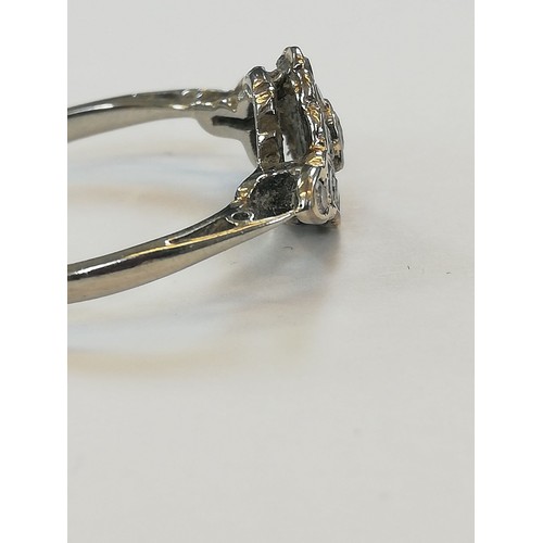 146 - An Edwardian diamond cluster ring, the central old cut diamond approximately 2.30mm diameter, with f... 