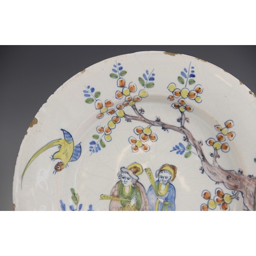 377 - An 18th century Delft tin-glazed earthenware plate, in the Fazackerley colour palette, decorated wit... 