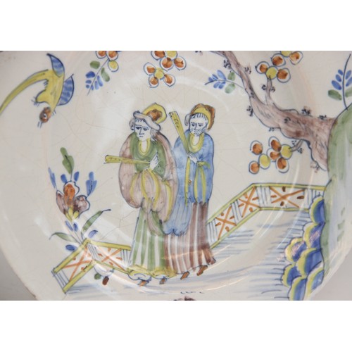 377 - An 18th century Delft tin-glazed earthenware plate, in the Fazackerley colour palette, decorated wit... 