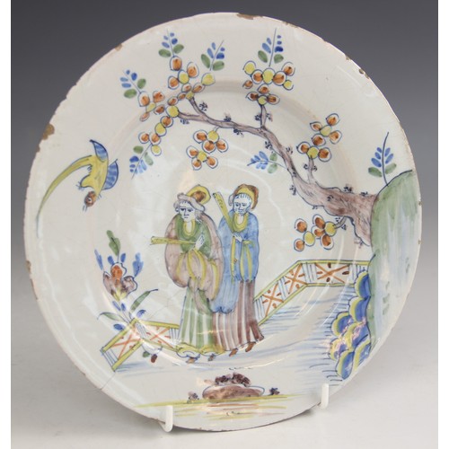 377 - An 18th century Delft tin-glazed earthenware plate, in the Fazackerley colour palette, decorated wit... 