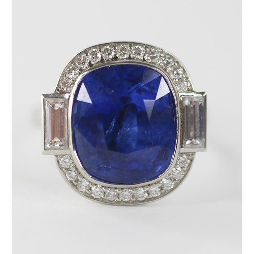 133 - An Art Deco Revival sapphire and diamond ring, the central cushion cut blue sapphire measuring appro... 