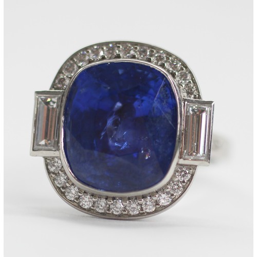 133 - An Art Deco Revival sapphire and diamond ring, the central cushion cut blue sapphire measuring appro... 