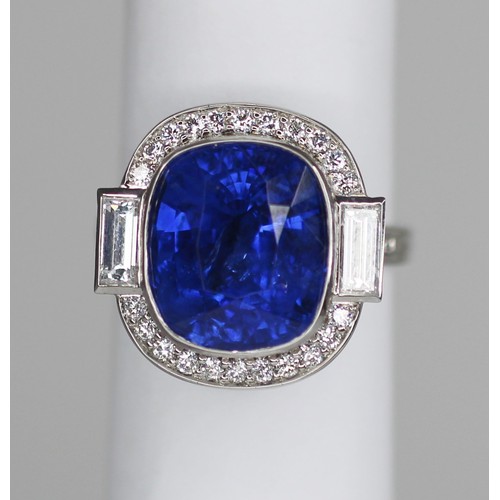 133 - An Art Deco Revival sapphire and diamond ring, the central cushion cut blue sapphire measuring appro... 