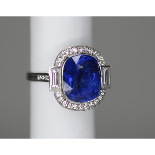 133 - An Art Deco Revival sapphire and diamond ring, the central cushion cut blue sapphire measuring appro... 