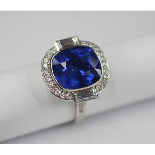 133 - An Art Deco Revival sapphire and diamond ring, the central cushion cut blue sapphire measuring appro... 