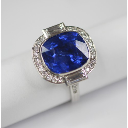 133 - An Art Deco Revival sapphire and diamond ring, the central cushion cut blue sapphire measuring appro... 