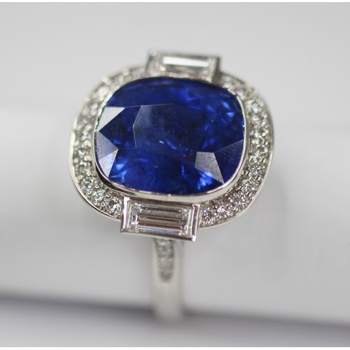 133 - An Art Deco Revival sapphire and diamond ring, the central cushion cut blue sapphire measuring appro... 