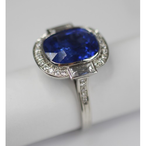 133 - An Art Deco Revival sapphire and diamond ring, the central cushion cut blue sapphire measuring appro... 