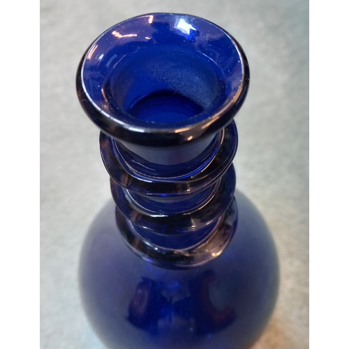 414 - A Georgian Bristol blue glass decanter, the mallet shaped body with triple ring neck, with bevelled ... 