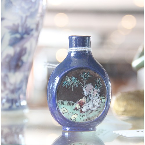 305 - A Chinese blue-ground Yixing stoneware snuff bottle, 19th century, decorated with two reserves depic... 