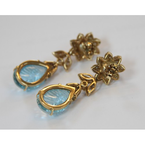 63 - A pair of blue topaz, pearl and diamond set 18ct gold drop earrings, each designed as a round cultur... 