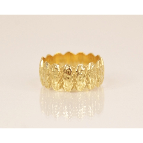 105 - An 18ct gold dress ring, the textured band with scalloped borders, marks for MS&S London (date lette... 