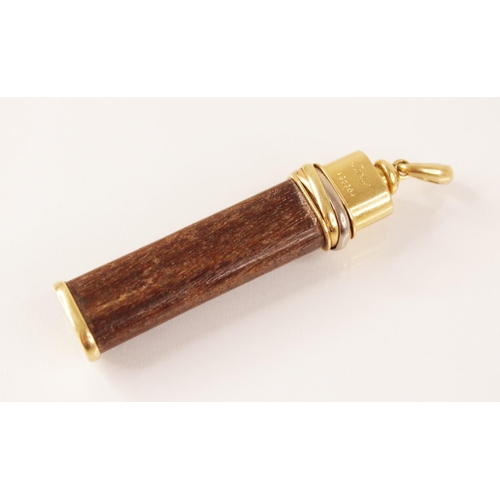 124 - A Cartier ‘Touch Wood’ pendant, the wooden baton topped with a three-colour trinity band, marked 'Ca... 