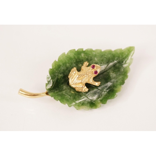 127 - An Italian novelty brooch by Cellino, modelled as a frog with ruby set eyes, sat upon a carved nephr... 