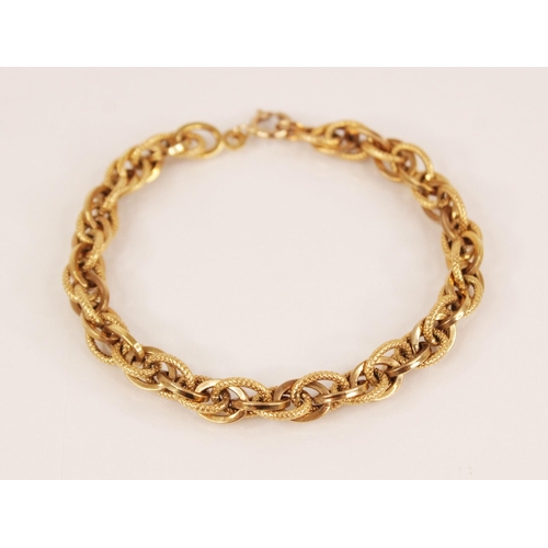 134 - An Italian 9ct gold bracelet by Unoaerre, comprising mixed plain polished and textured oval links, s... 