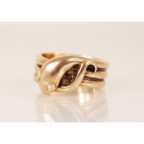 138 - A 9ct gold snake ring, the snakes head modelled with diamond shaped eyes and coiled tail to a reeded... 