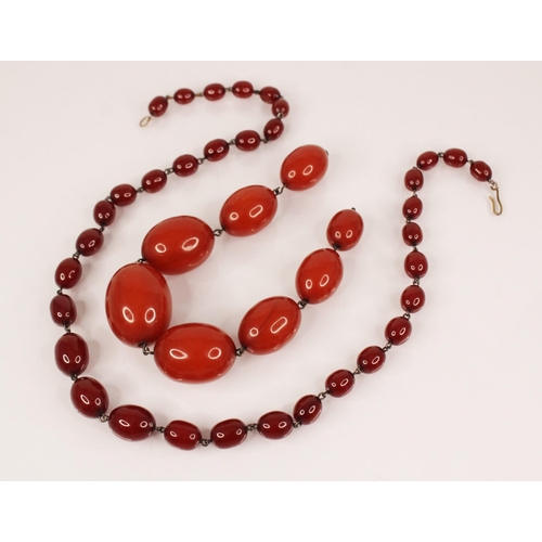 150 - A cherry amber bead necklace, comprising thirty-four polished oval cherry amber beads, measuring bet... 