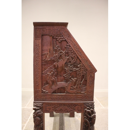 384 - A Chinese relief carved hardwood bureau, 20th century, the fall front carved with warriors on horse ... 