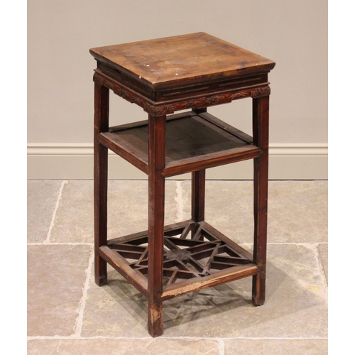 385 - A Chinese elm bedside table, 20th century, the cleated square top above a sliding tray, raised upon ... 