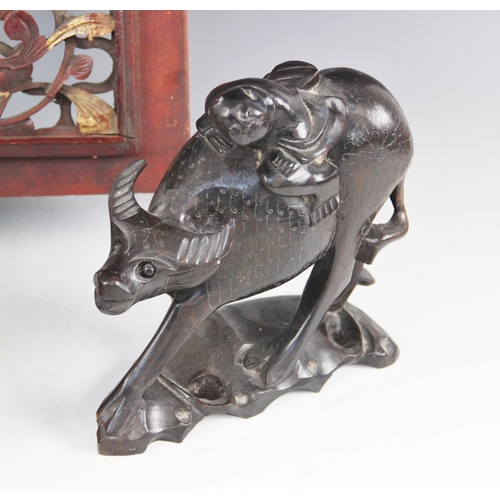 413 - A pair of Chinese hardwood models of water buffalo and riders, each 18cm high, with an oriental pier... 