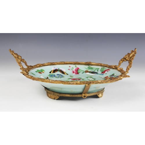 420 - A Chinese porcelain Celadon comport, 19th century, the gilt metal mounted dish decorated in a famill... 