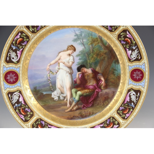 437 - A late 19th century continental porcelain painted charger, the centre depicting a sleeping Mars and ... 