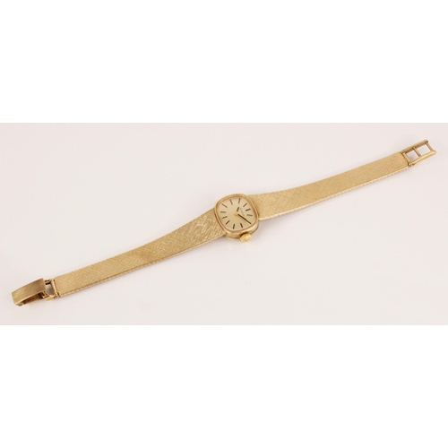 63 - A ladies vintage 9ct gold Bulova wristwatch, the cushion shaped dial with black baton markers, set t... 