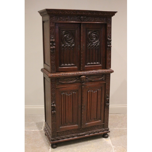 771 - A Victorian carved oak collectors/specimen cabinet in the 17th century taste, the upper cabinet door... 