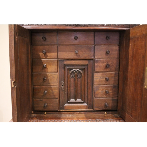 771 - A Victorian carved oak collectors/specimen cabinet in the 17th century taste, the upper cabinet door... 